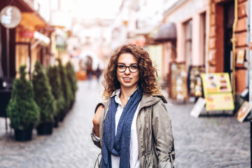 Pretty curly girl walking on the street