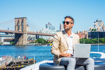 Young European Businessman traveling, working in New York, with beard, little gray hair, wearing...
