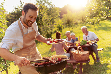 Happy family having barbecue party in backyard - obrazy, fototapety, plakaty