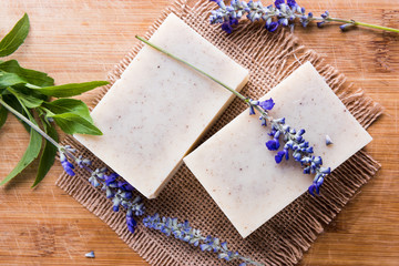 Handmade soap bars with lavender flowers on wooden table