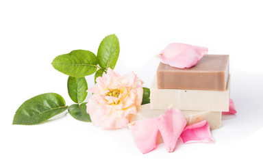 Handmade soap with flower petals on white background