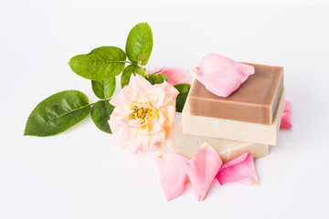 Handmade soap with flower petals on white background