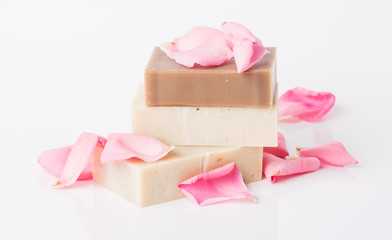Handmade soap with flower petals on white background
