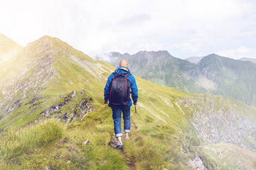 Man blogger with camera exploring Fagaras Mountains