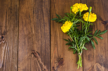 Fototapeta na wymiar Yellow Tagetis on wooden table
