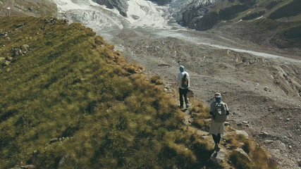 Fototapeta na wymiar Drone view hiking people traveling a mountain. Tourist group climbing a mountain