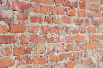 Fototapeta premium Closeup of old vintage red brick wall. brick wall of dark stone texture. Perspective view. Selective focus