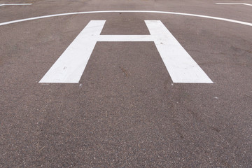 Closeup of helipad for landing helicopters on asphalt ground