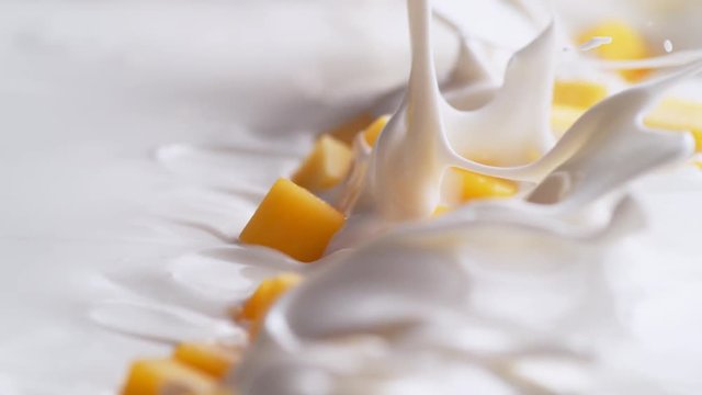 Tossing diced mango in yogurt. Shot with high speed camera, phantom flex 4K. Slow Motion.
