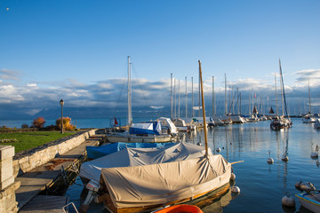 Mooring Boats and Marina on Leman Lake at Sunset with Alps in the Background.