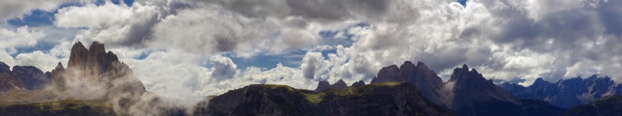 Panoramic view of the Three Peaks in wispy clouds, the most famous hiking destination and landmark...