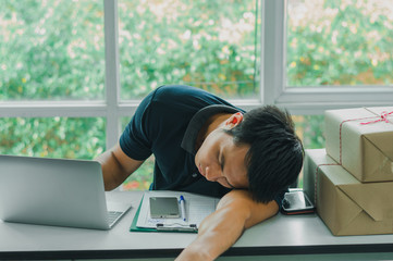 The postman is asleep while preparing a mailbox to send to the recipient. Delivery concept