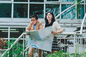 Asian men and women watching tourist map