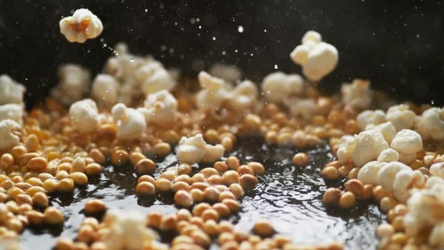 Popcorn popping on heated fry pan. Shot with high speed camera, phantom flex 4K. Slow Motion.