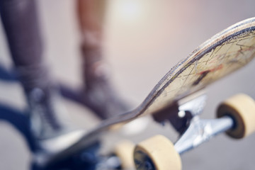 Skateboarder doing a trick in a skate park, close-up old skateboard