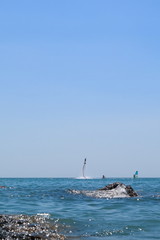 Walk on the sea on a board with a sail. Flying on a water jet.