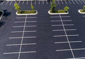 parking lot,asphalt,island,trees,stalls,parking stalls,paint,green