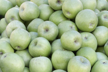 A backround of lots of green apples