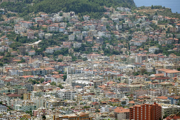 Fototapeta na wymiar Panorama of the city. Numerous houses of the coastal city. The view from the height of bird flight.