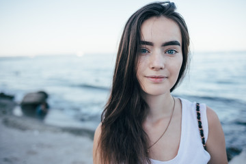 Pretty teen girl on the background of blue sea