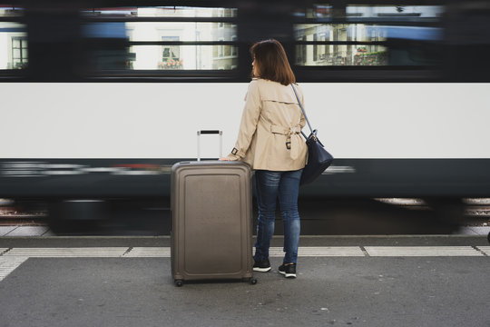 A girl is wating a train in a trian station at Geneva, Switzerland.