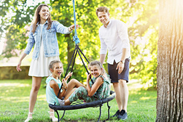 Joyful family having fun on playground