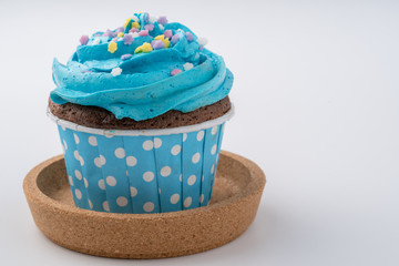 Tasty colorful cupcake isolated on white background, close up.