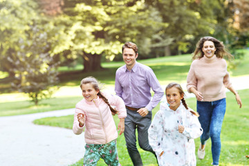 Young family with children having fun in nature