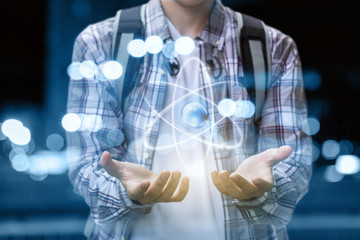Student shows hands atom .