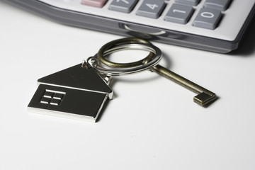House key chain, bronze key  and calculator