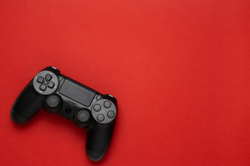black gamepad on a red. Gaming concept