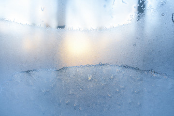 Frozen winter window with and morning sun.