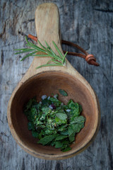 Natural spices and herbs on a rustic wooden table