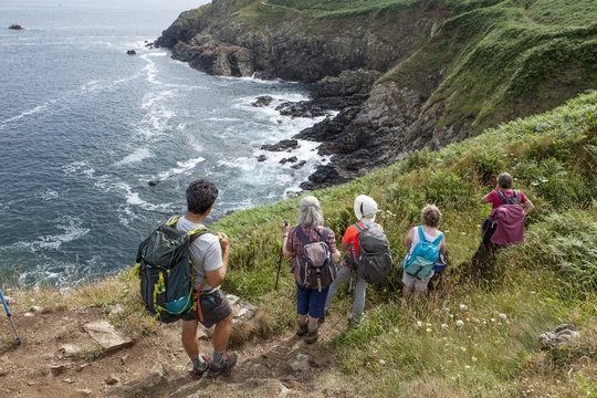 group of hikers looking at the ocean
