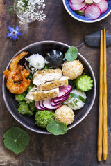 Bento box with onigiri, prawns and vegetables