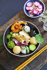 Bento box with onigiri, prawns and vegetables