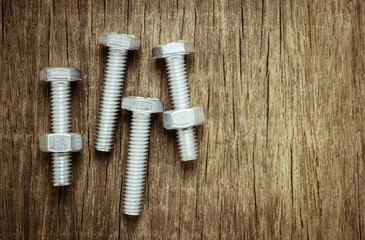 Fototapeta premium nuts and bolts on abandoned wood desk.