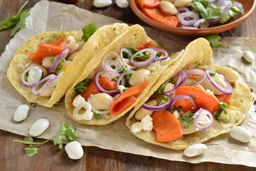 Tortilla, tacos with vegetables: pumpkin, white beans, goat cheese and onions