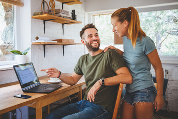 Young couple working on laptop, teamwork
