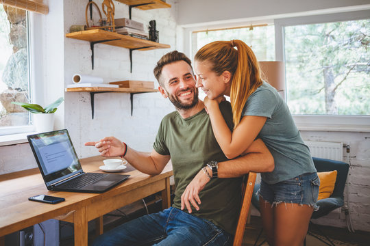 Young couple working on laptop, teamwork