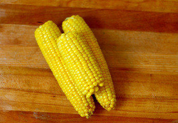 Piled,organic corn on wooden board background 4