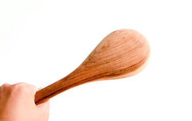 Hand holding wooden turner, cooking time