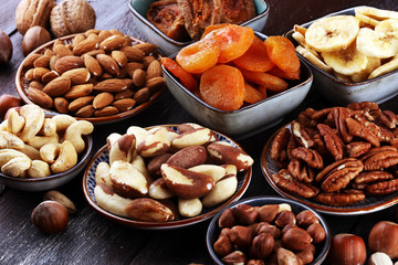 dried fruits and assorted nuts composition on rustic table