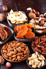 dried fruits and assorted nuts composition on rustic table