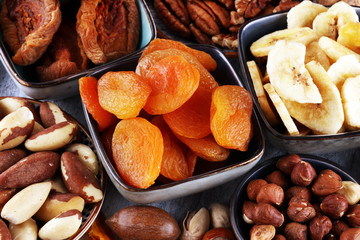 dried fruits and assorted nuts composition on rustic table