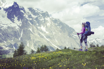 Obraz premium The girl is traveling in Iceland with a backpack and a tent.
