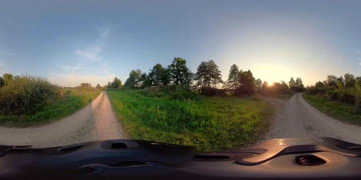 360VR video. Woman mountain biking at sunset