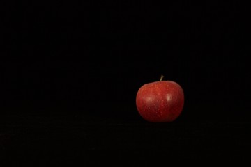 Single or group of apples including granny smith, golden delicious and royal gala on a black background.