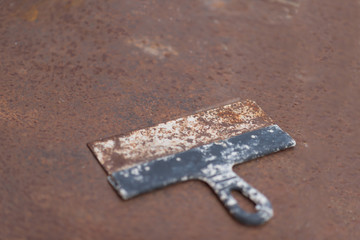 Old spatula on a rusty metal