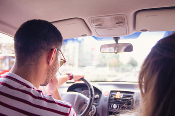 Young Couple Driving in a Car